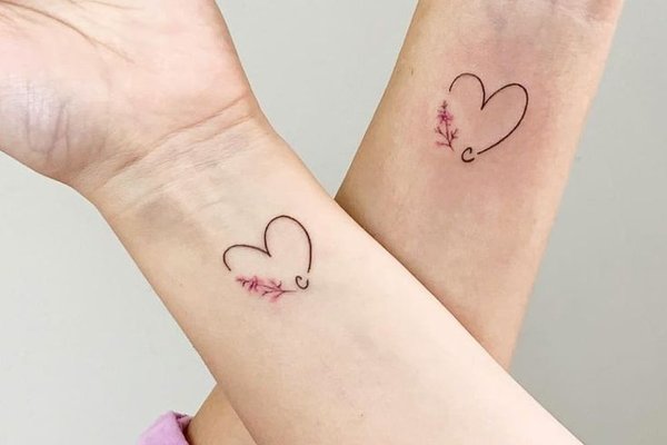 Feines Tattoo mit Herz und Buchstaben als Freundschaftssymbol