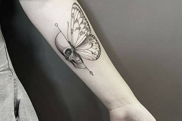 Tattoo-Design mit Schmetterlingsflügeln und Schädel in der Mitte